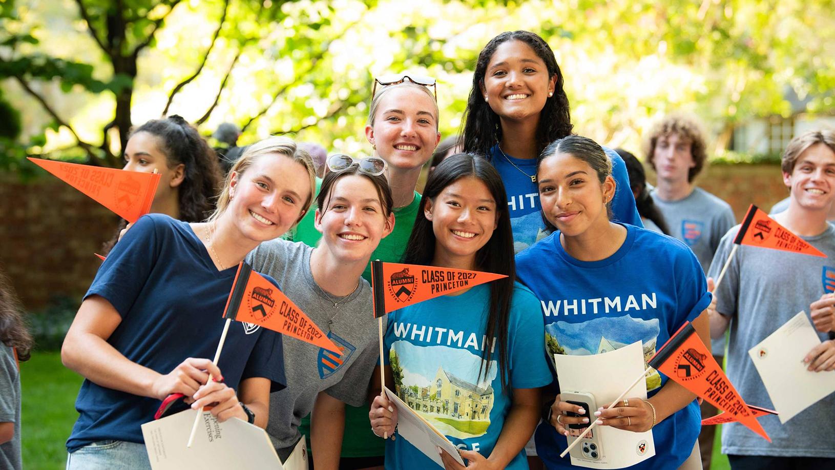 A group of students wave their Princeton Class of 2027 pennants