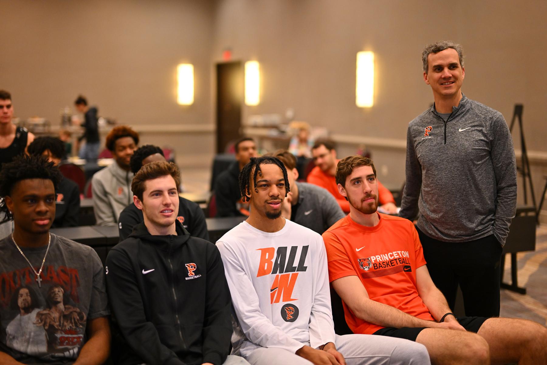 Mitch Henderson and members of the men's basketball team participate in media day at the 2023 NCAA Tournament.