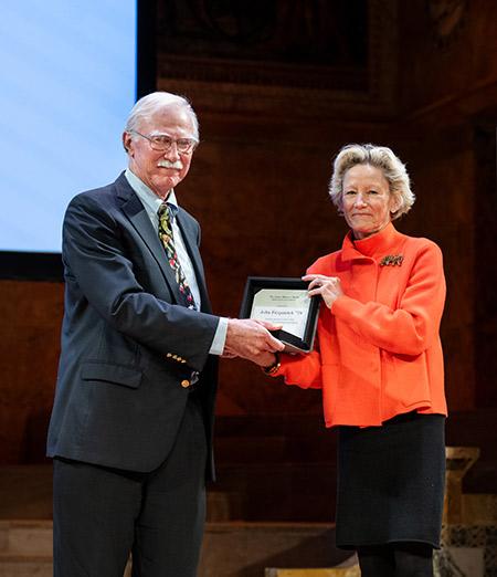 Weezie Sams presents the Madison Medal to John Fitzpatrick in Richardson Auditorium