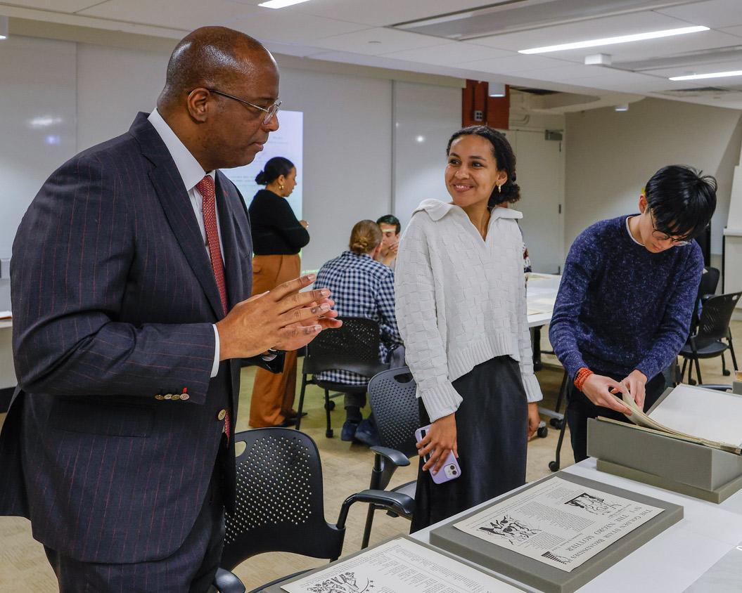 Dean of the Faculty Gene Jarrett (left) examines Black and African American archival materials from the Princeton University Library Special Collections with students in a 2024 Wintersession workshop, “Innovating the Archive from Phillis Wheatley to Toni Morrison.