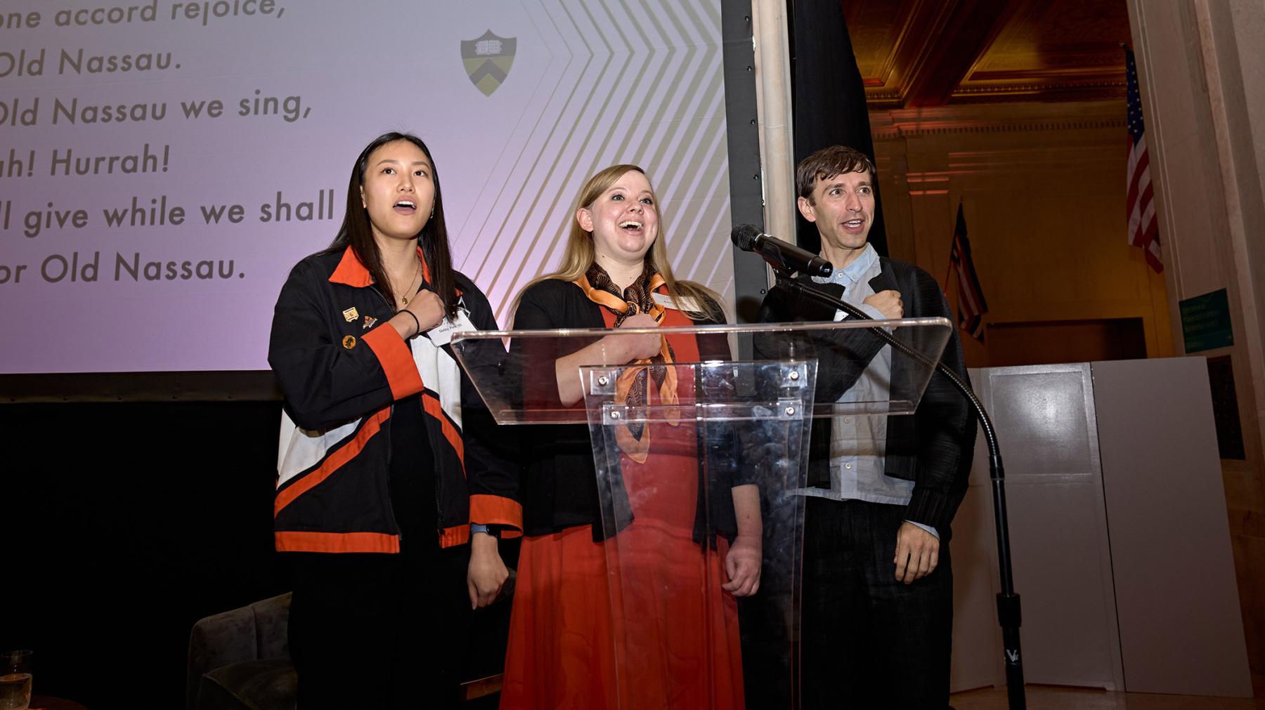 Debby Park ’22, Katie Knorr ’13 and Anthony Roth Costanzo ’04, stepped forward on stage to lead the audience in the singing of “Old Nassau.” 